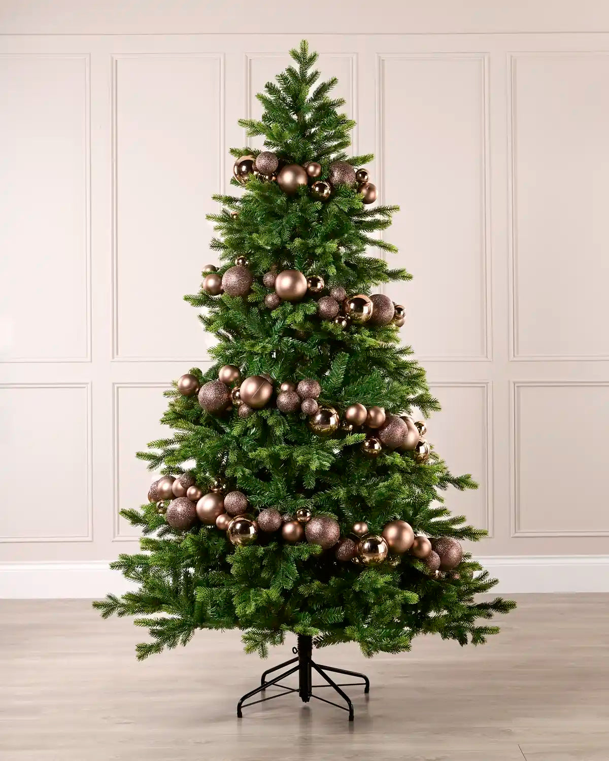 Mocha bauble garland wrapped around a green Christmas tree with shiny, matt and glitter baubles.