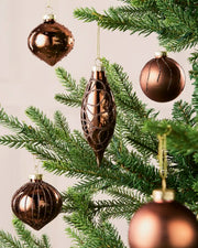 Mixed mocha glass baubles with matt, shiny and glitter finishes on a Christmas tree.