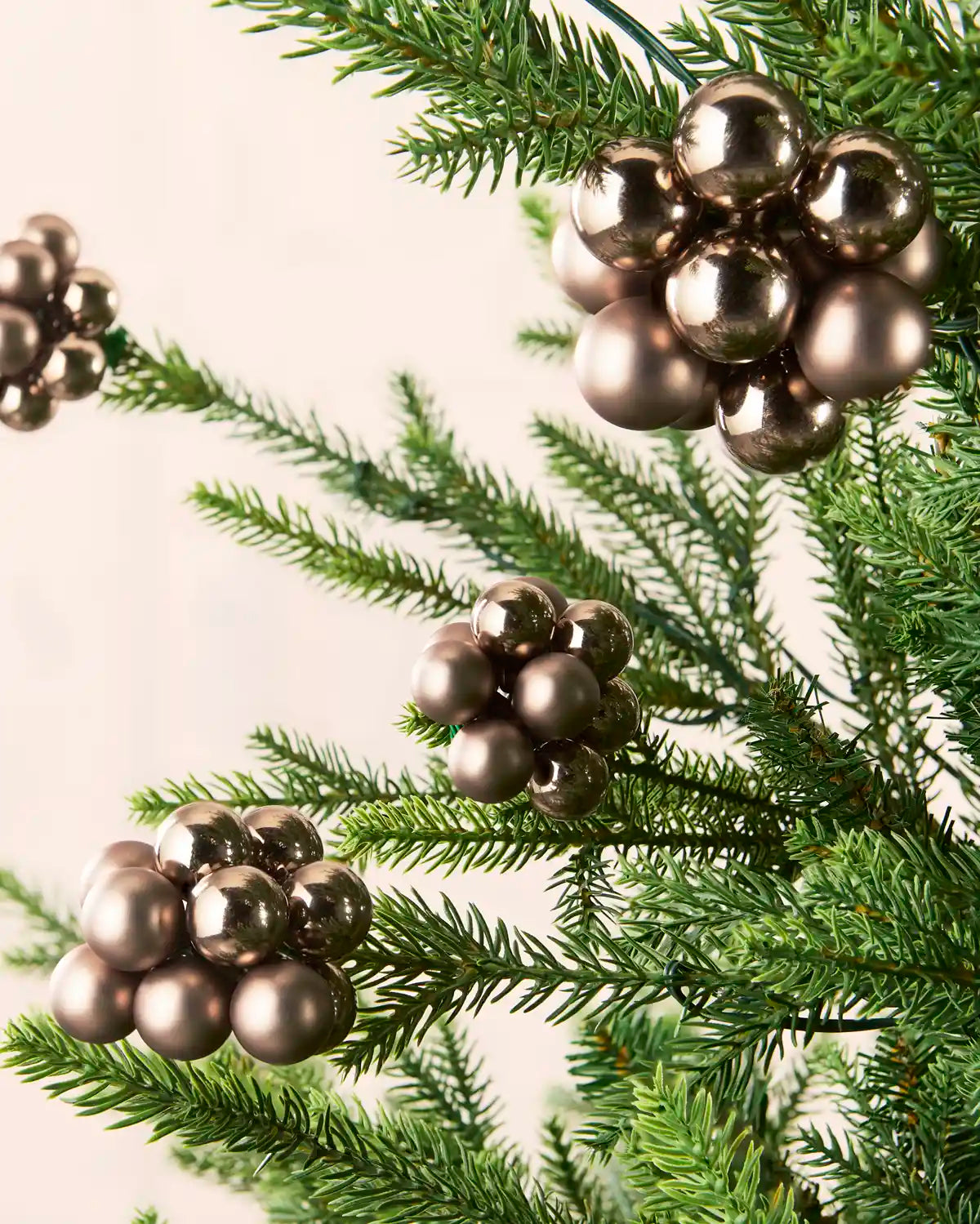 Mocha berry cluster baubles with mixed shiny and matt glass finishes displayed on Christmas branches.