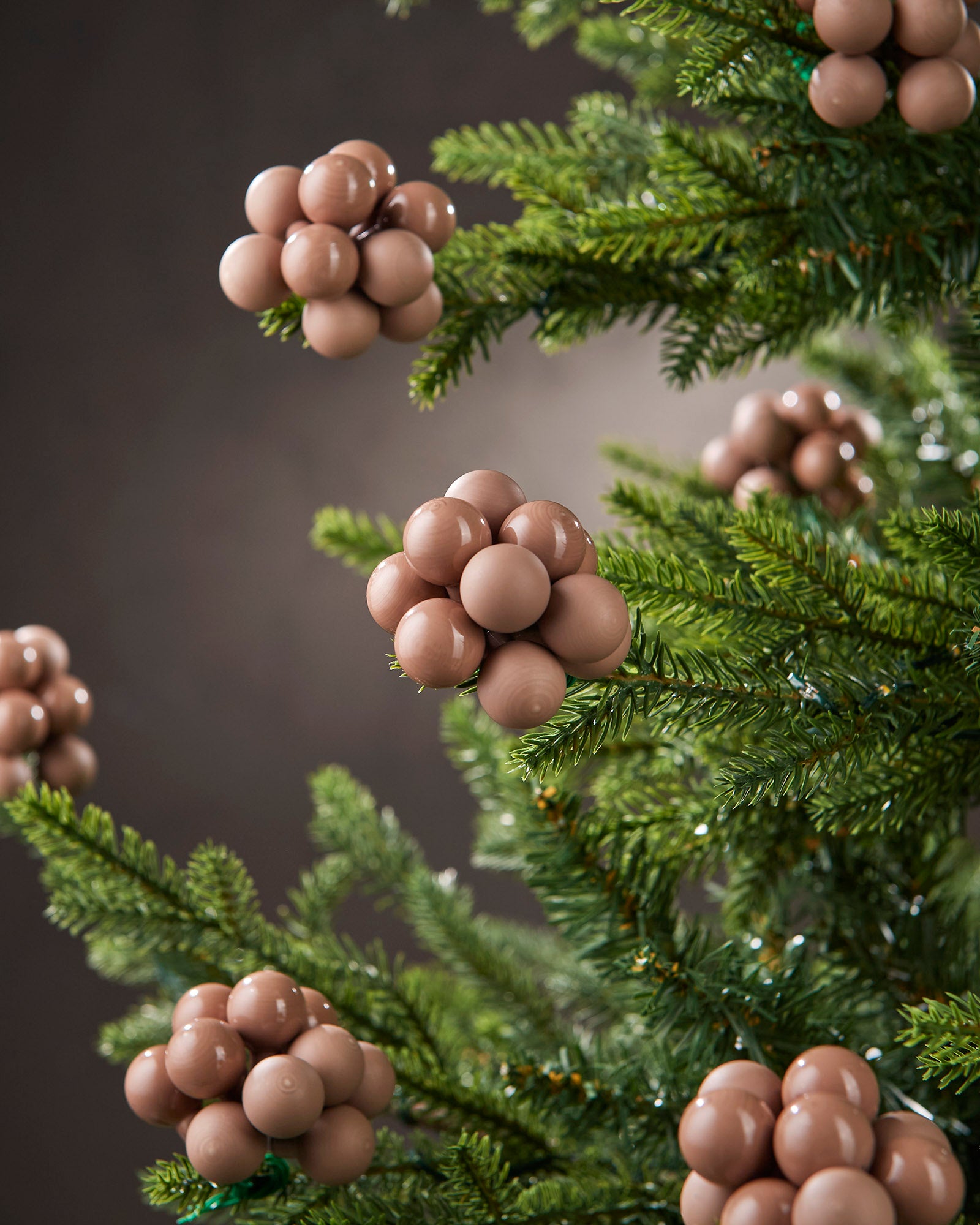 Mocha glass berry cluster baubles arranged on a green Christmas tree.