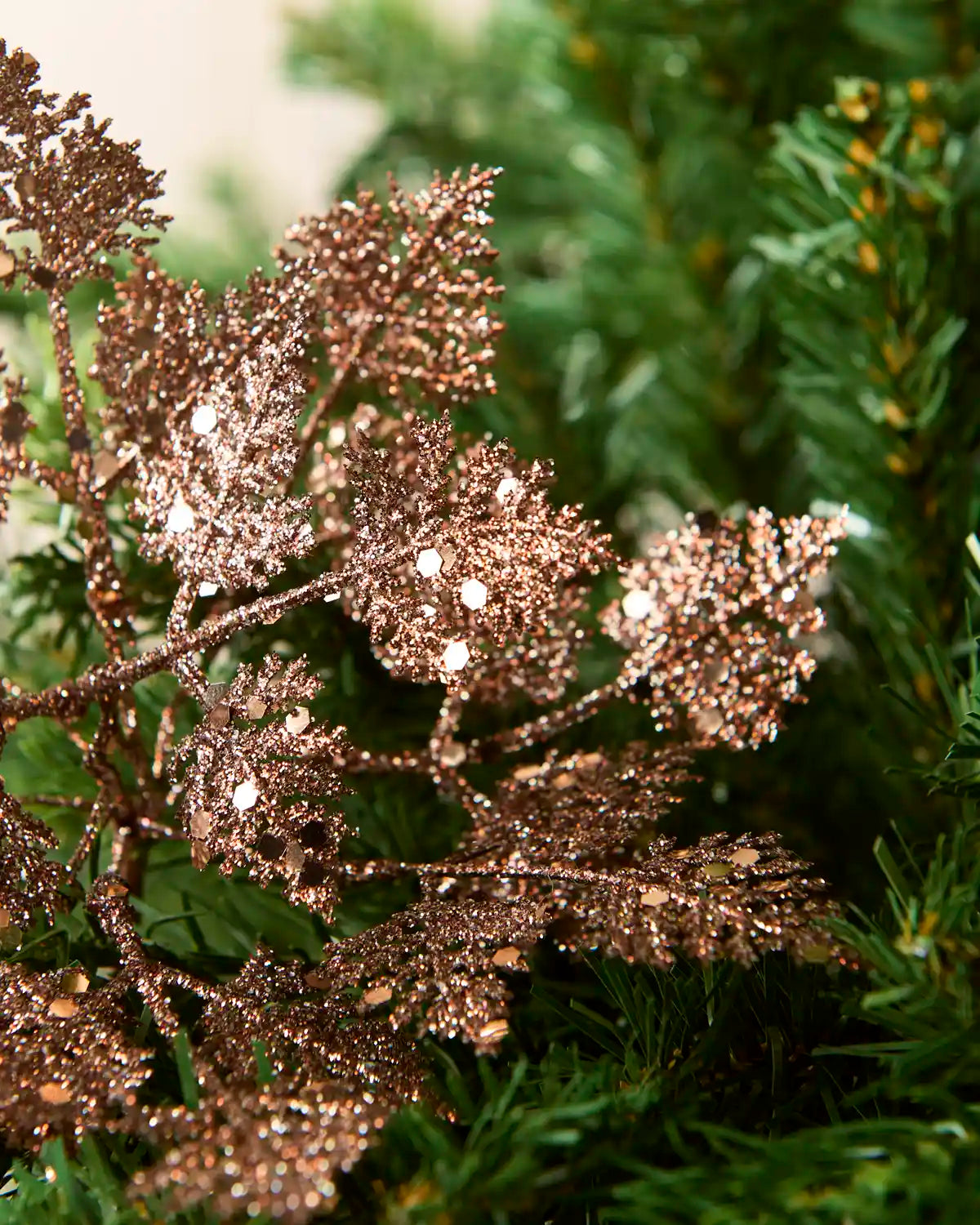Close-up of mocha glitter leaves with fine branching details and a light-catching finish.