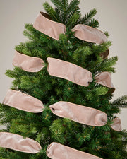 Mocha velvet ribbon wrapped around a Christmas tree as a soft festive decoration.