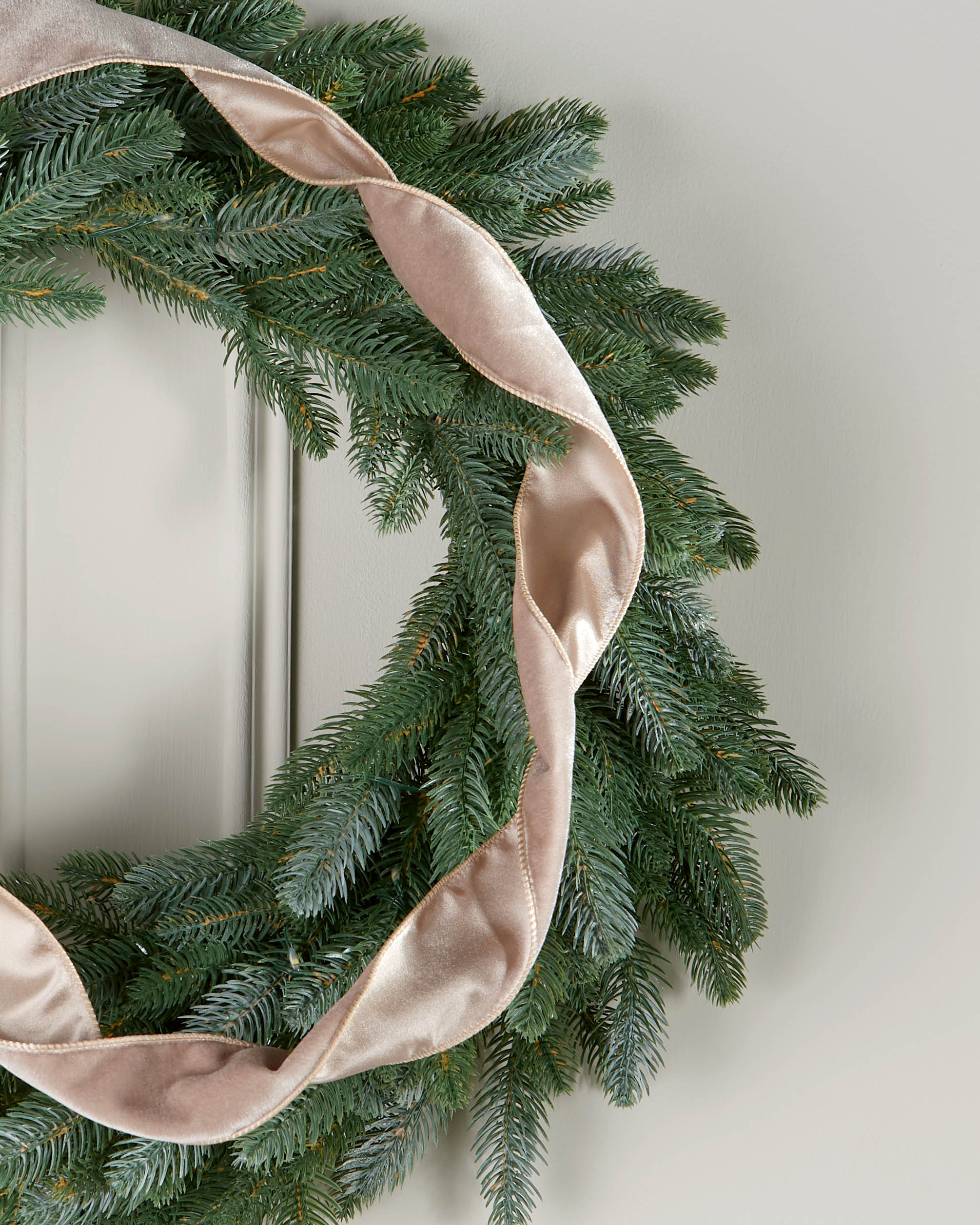 Mocha velvet ribbon styled in a loose spiral on a green Christmas wreath.