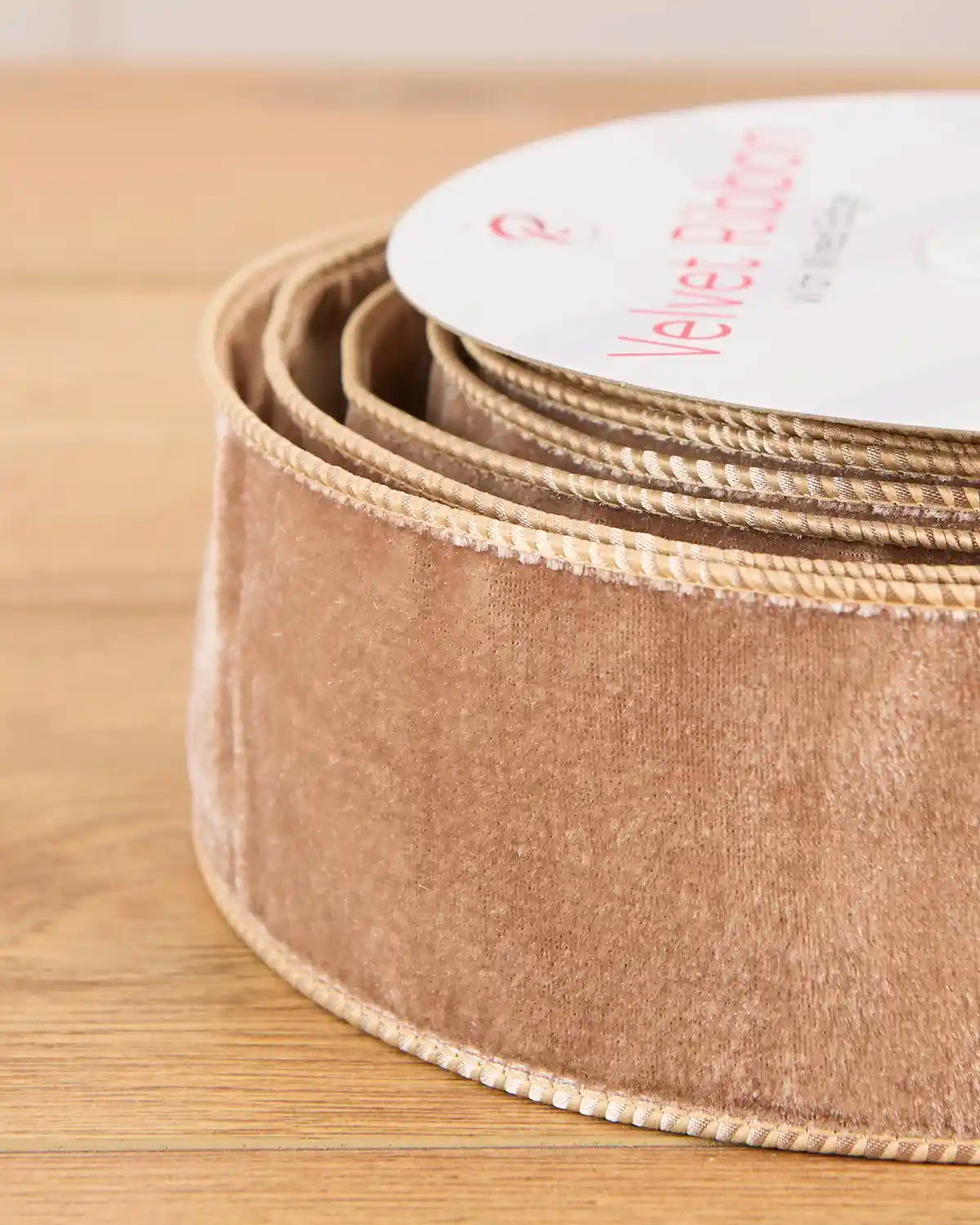 Close-up of the soft mocha velvet texture and reinforced wired edges on the 6 cm Christmas ribbon.