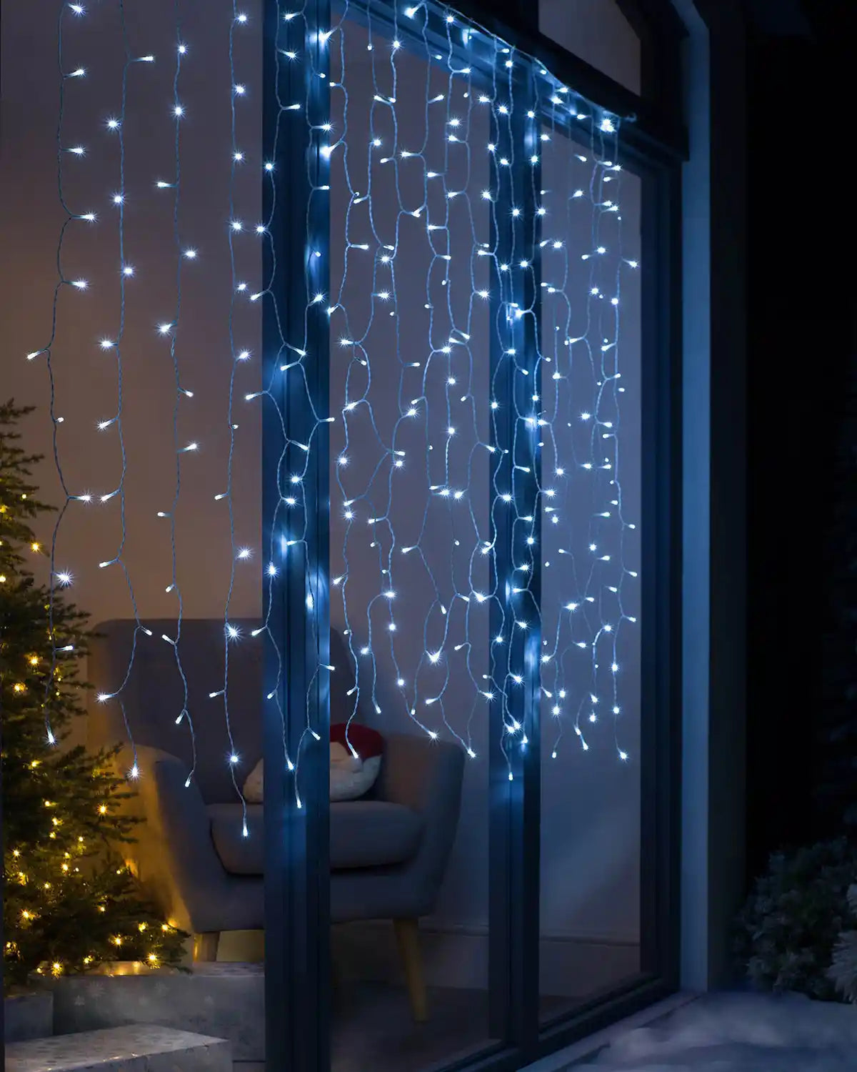 Full display of bright white connectable curtain lights draped across a window