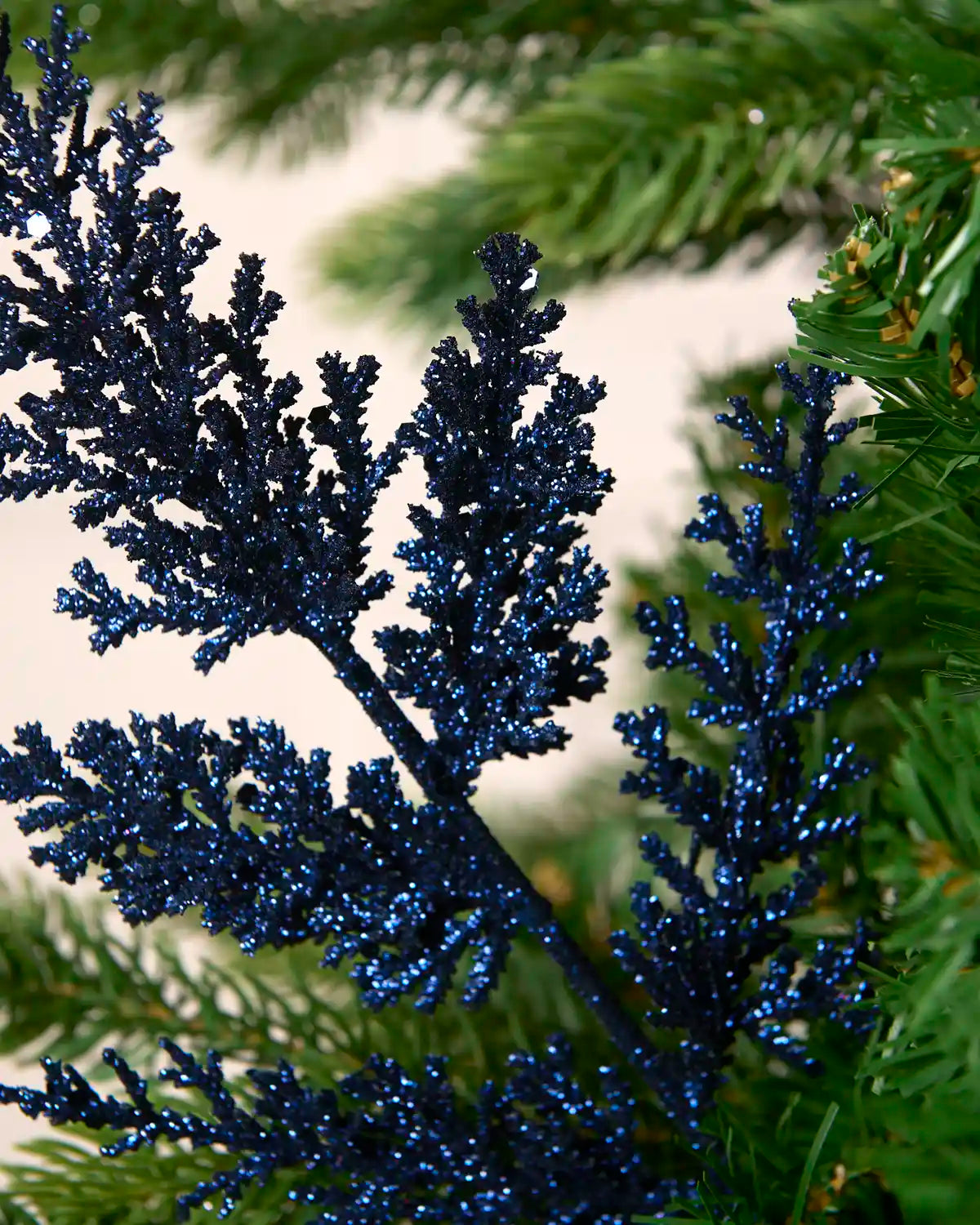 Close-up of a navy glitter leaf pick showing dense sparkling foliage detail.