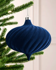 Navy 20 cm oversized velvet bauble with spiral detailing, silver cap and hanging string on a Christmas tree.