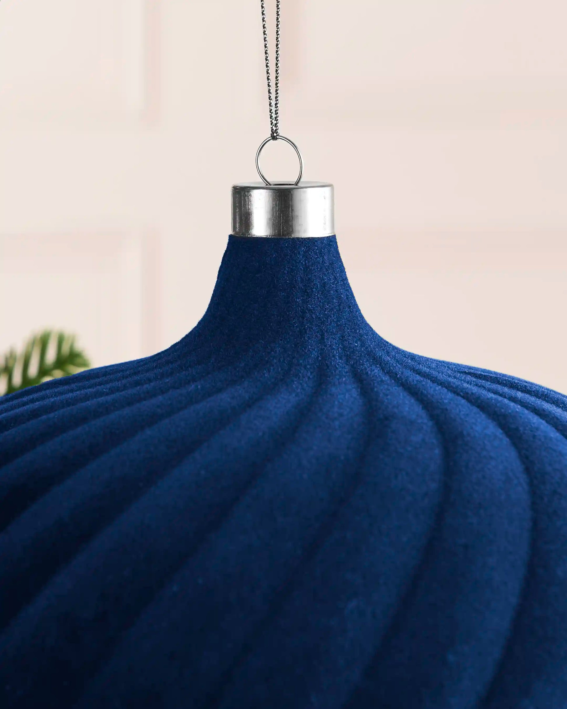 Close-up of the navy velvet spiral detailing, silver metal cap and hanging string on the 20 cm bauble.