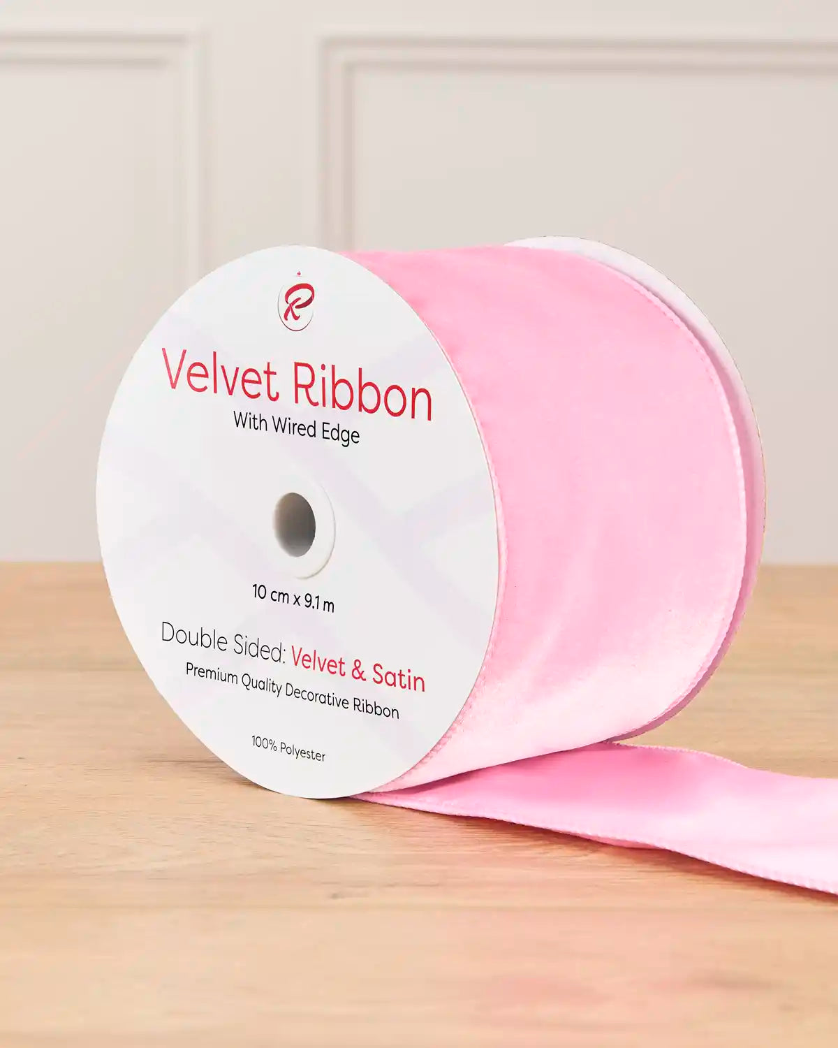 10 cm wide pink double-sided wired velvet ribbon on a 9 m roll with product label.