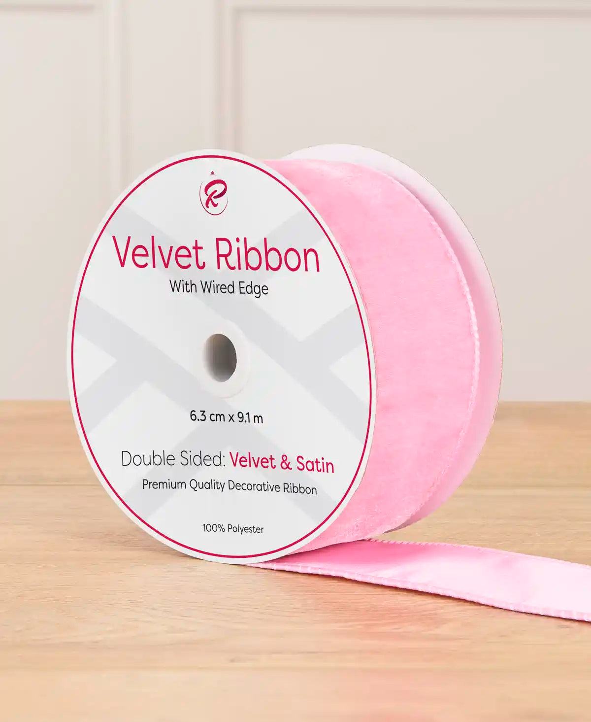 6 cm wide pink double-sided wired velvet ribbon on a 9 m roll with product label.