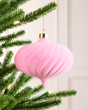 Pink 15 cm oversized velvet spiral bauble hanging on a Christmas tree with a gold cap and hanging string.