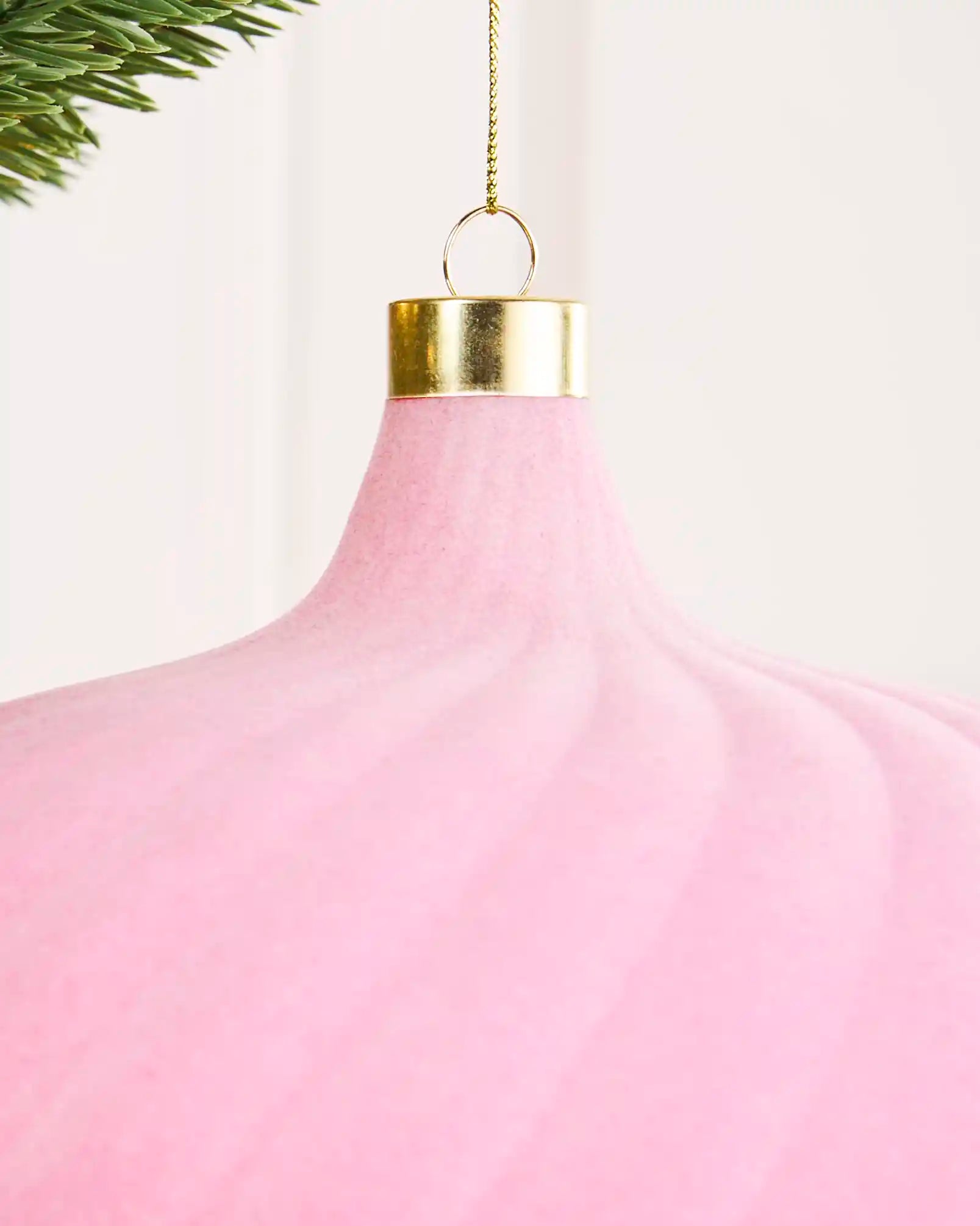 Close-up of a pink 20 cm oversized velvet spiral bauble showing the soft finish, spiral detail and gold cap.