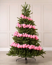 Pink velvet bauble garland wrapped around a green Christmas tree with mixed 5cm, 7cm and 10cm baubles.