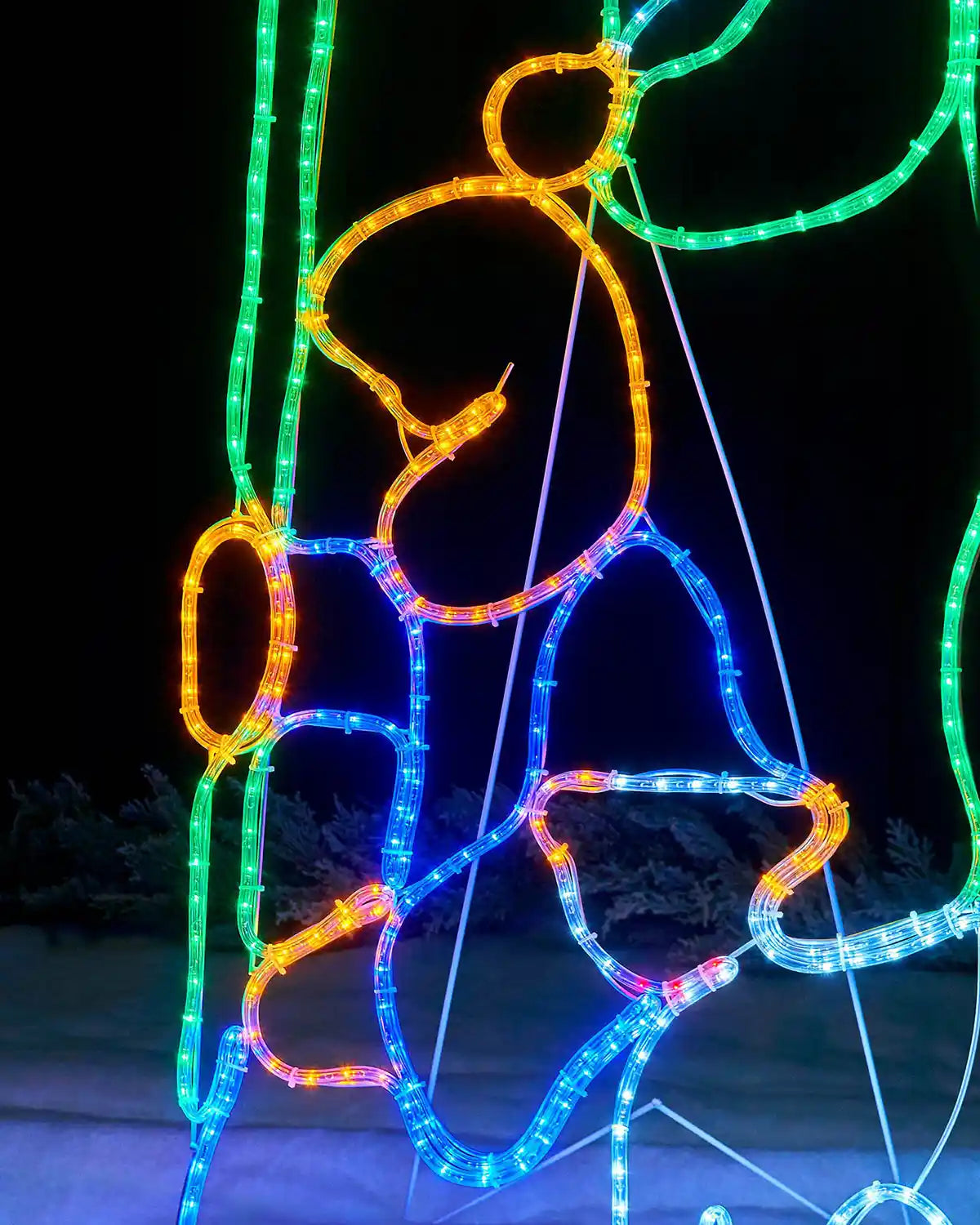 Close-up of the kneeling shepherd figure in multi-coloured rope lights