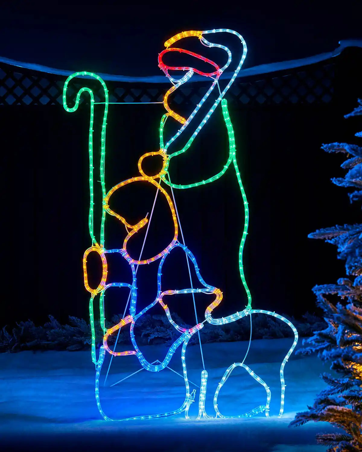 Pre-lit 2 shepherds with sheep silhouette rope light displayed outdoors at night