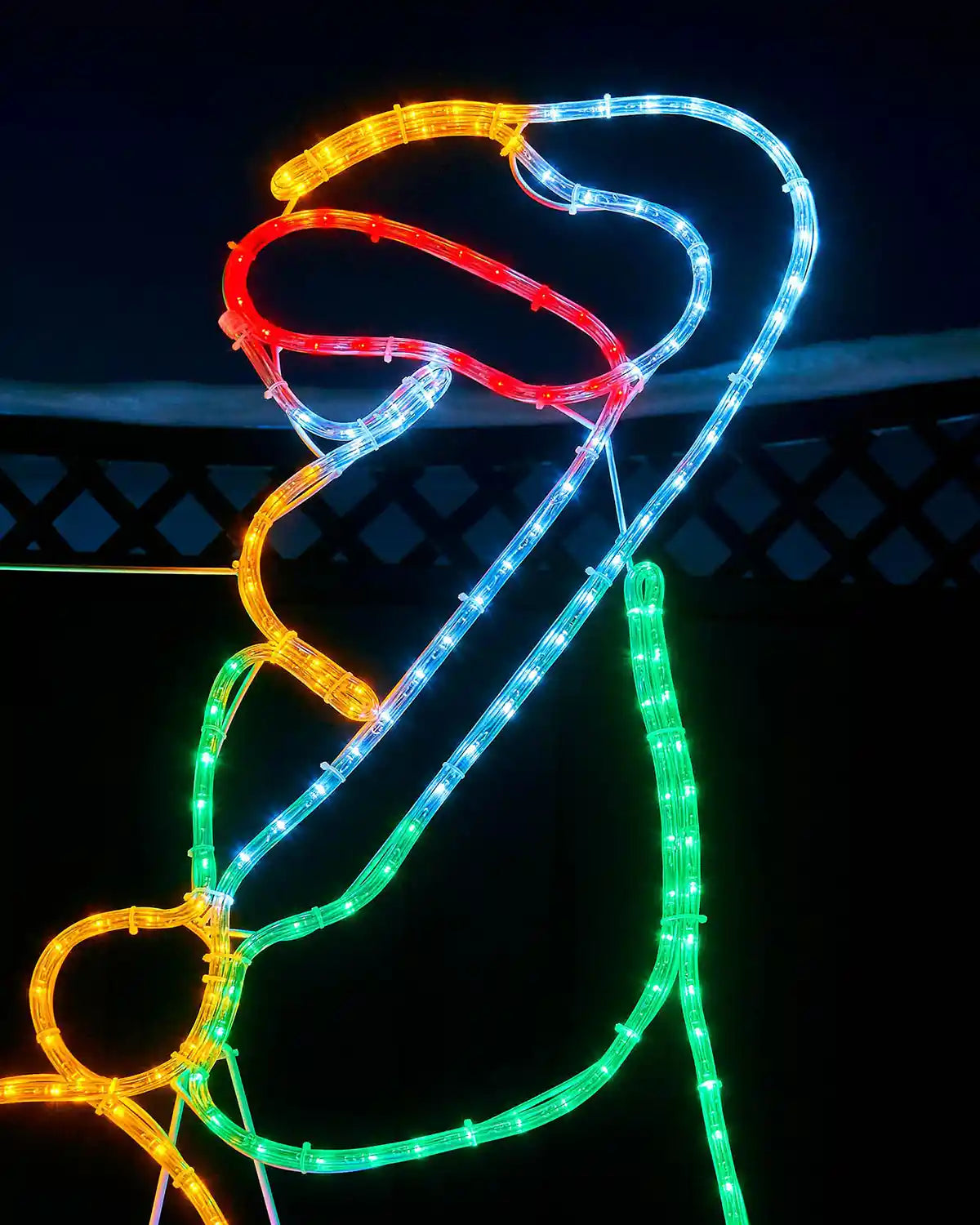 Close-up of the standing shepherd figure with crook in multi-coloured rope lights