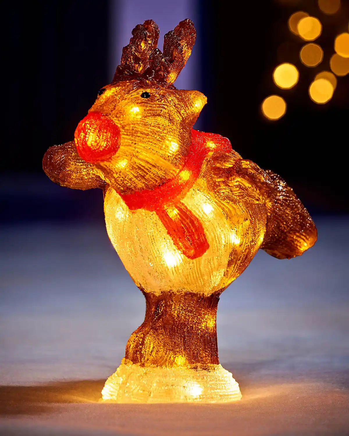 Front view of illuminated acrylic reindeer figurine with red scarf and glowing LED lights