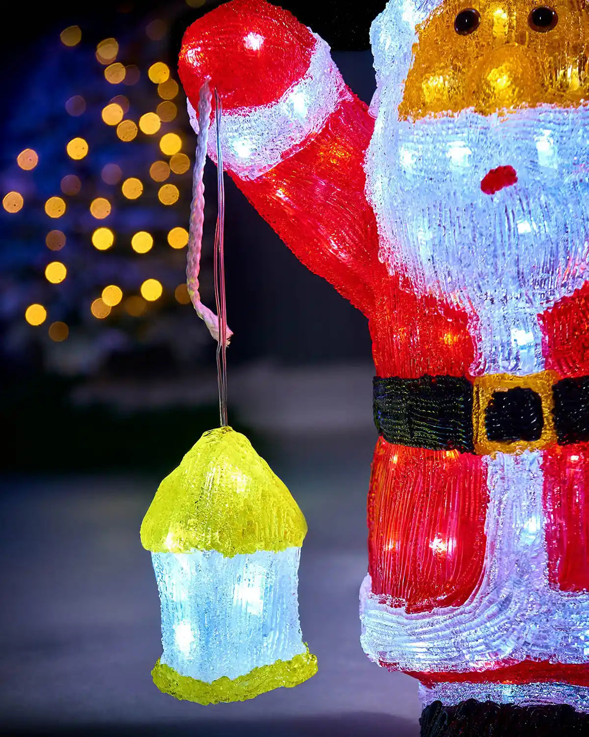 Close-up of the glowing lantern held by the pre-lit acrylic Santa figurine