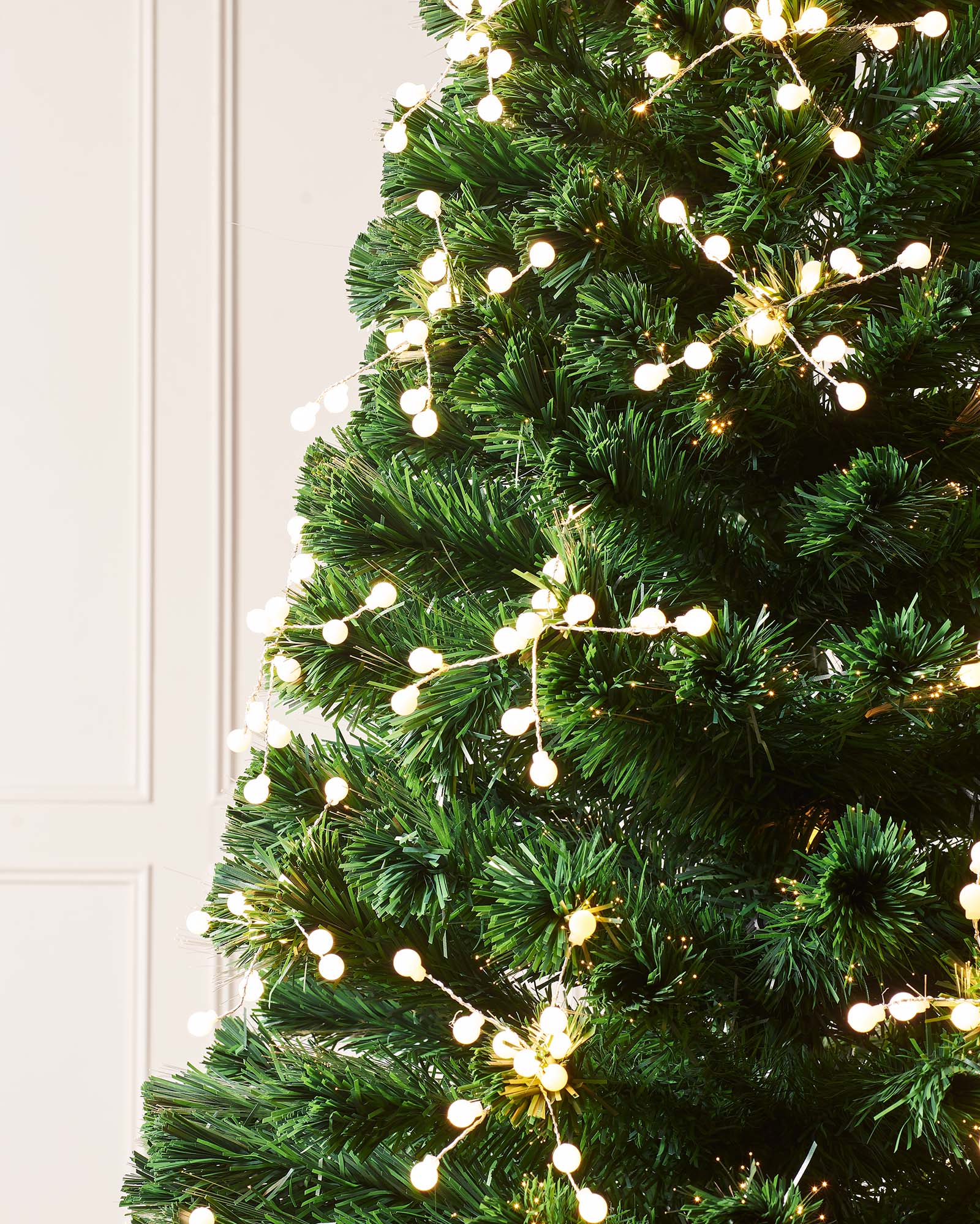 Close-up of warm white berry cluster lights on the fibre optic tree