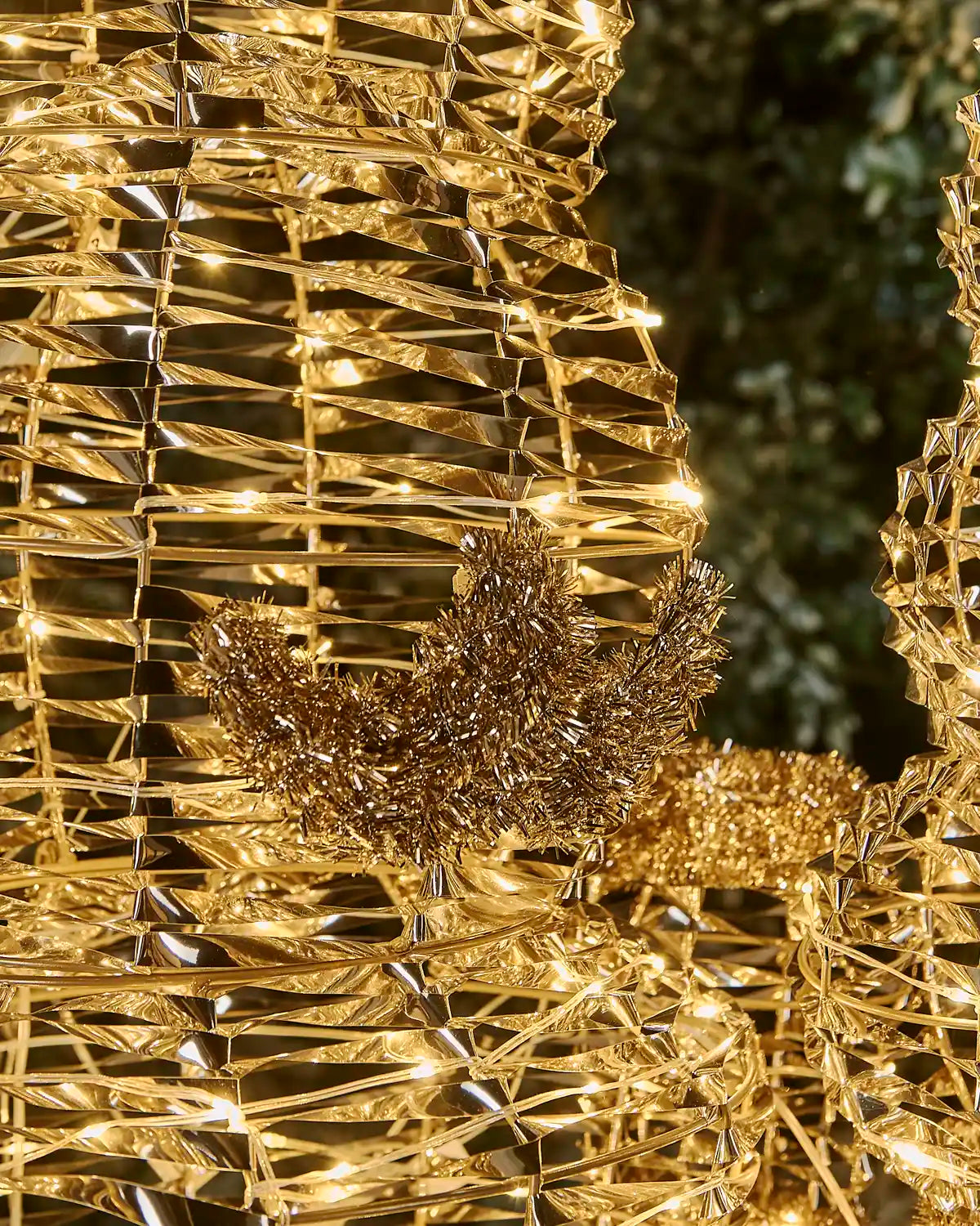 Close-up of the gold nutcracker’s tinsel moustache and illuminated woven metallic construction.