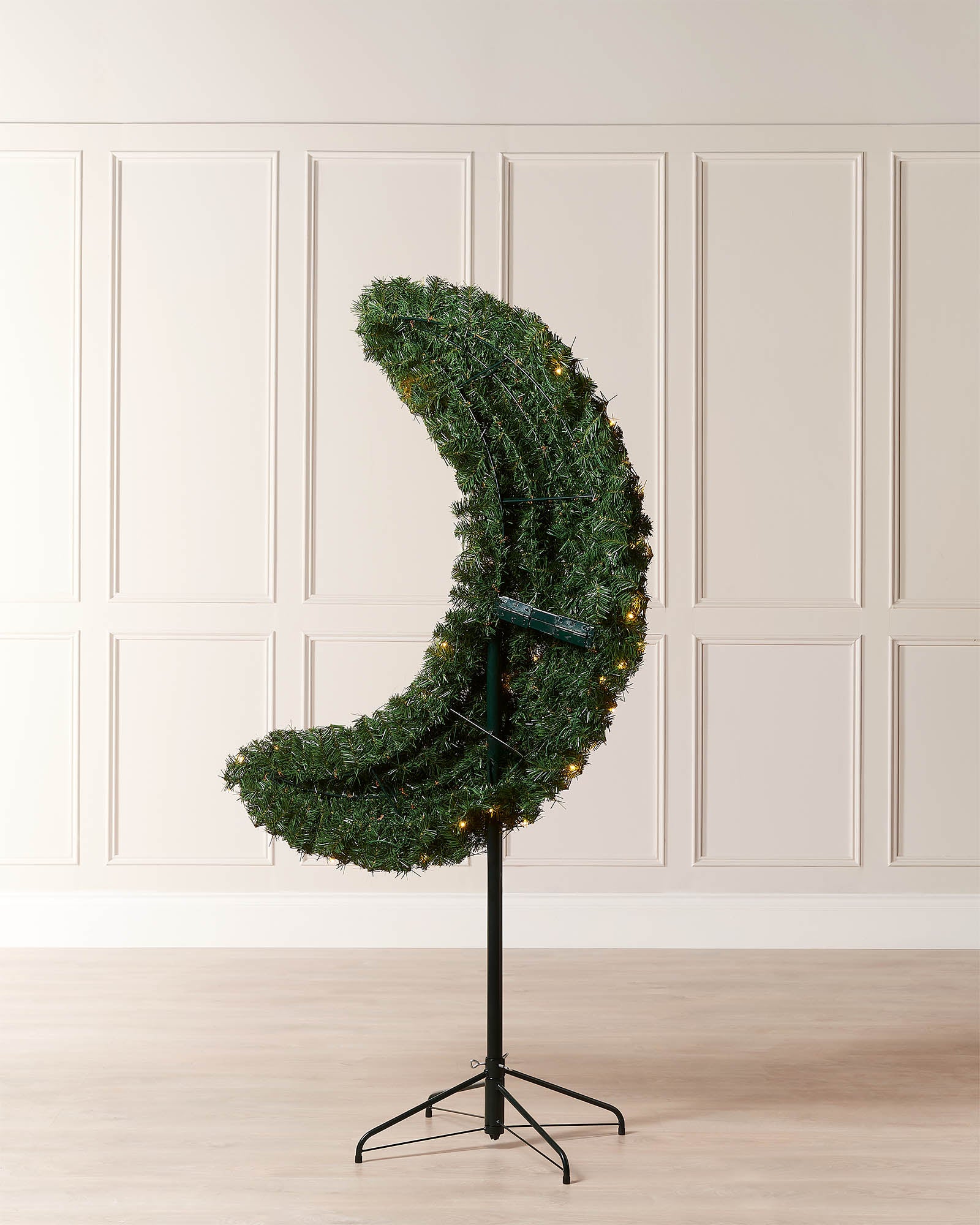 Rear view of the 6ft half moon Christmas tree showing the flat-back frame and metal tree stand.