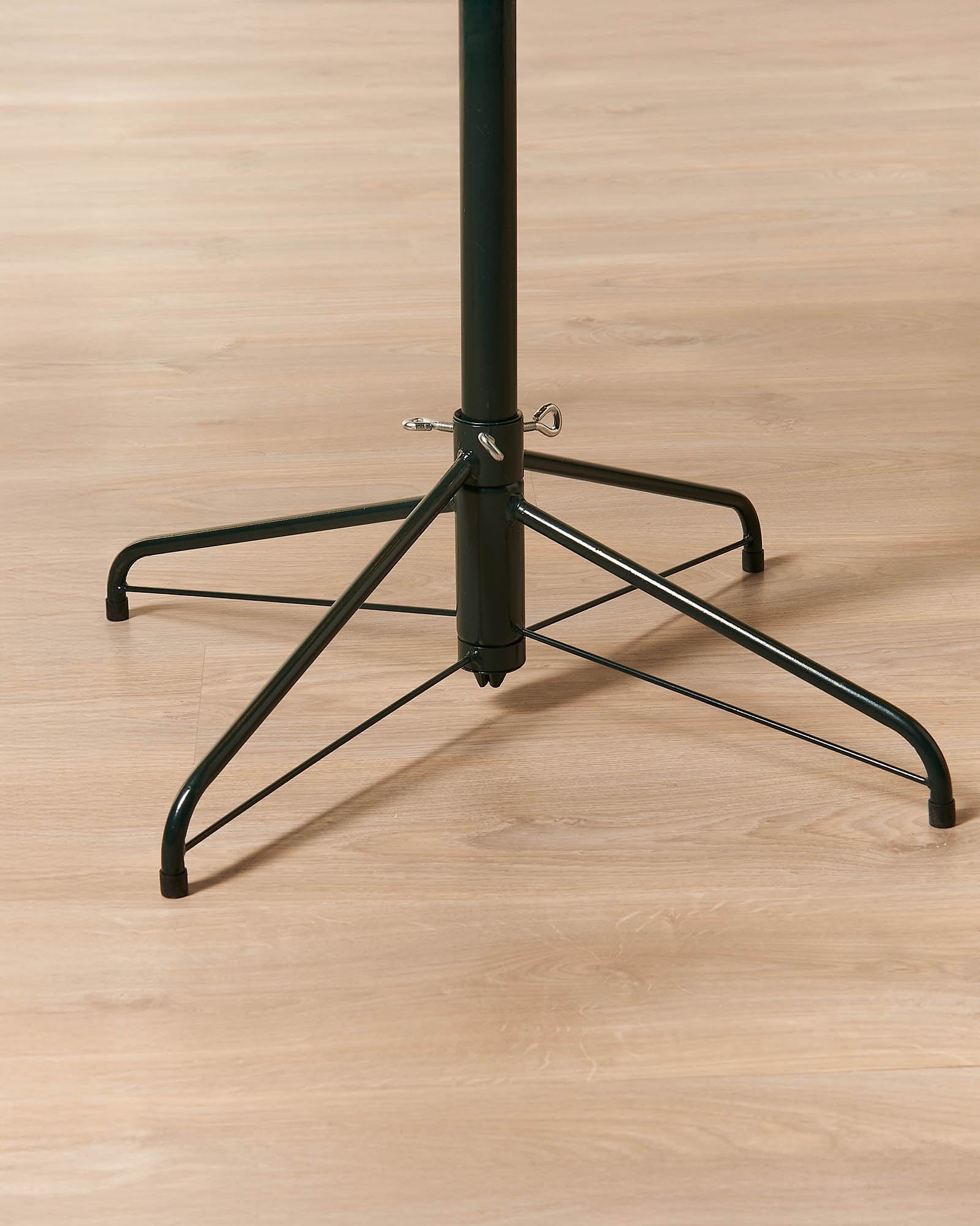 Close-up of the metal tree stand for the 6ft pre-lit half moon Christmas tree.