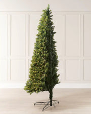 Side view of a pre-lit mixed pine half Christmas tree designed to sit against a wall.