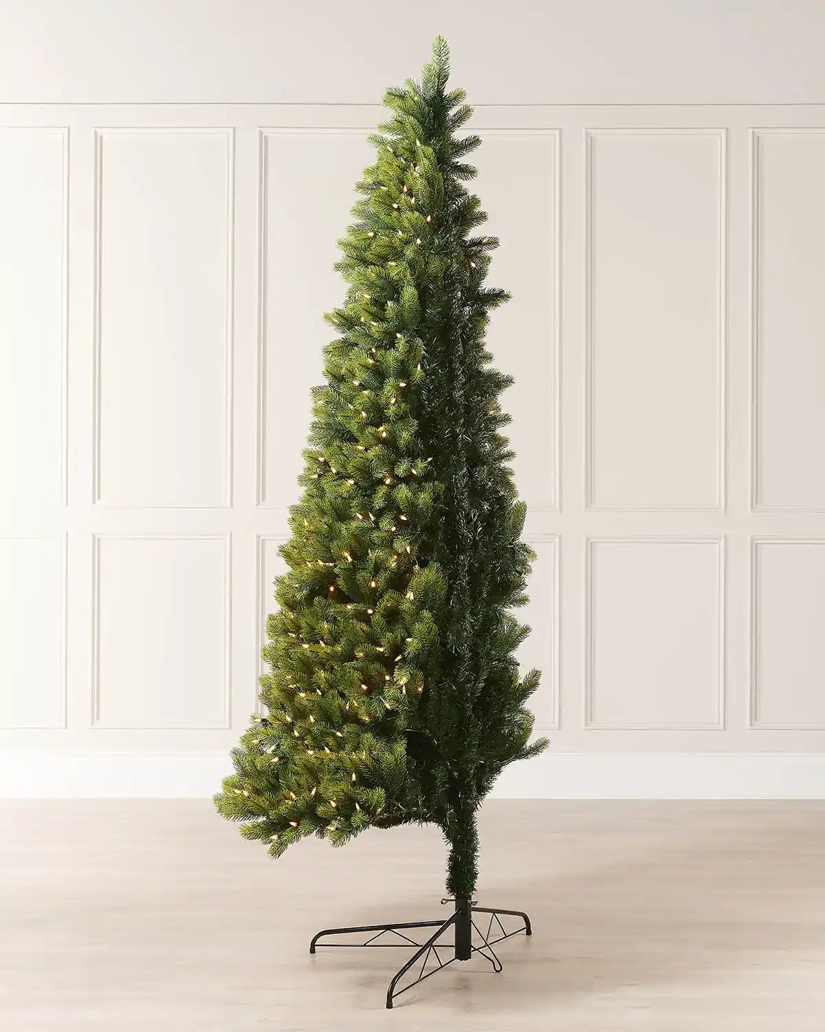 Side view of a pre-lit mixed pine half Christmas tree designed to sit against a wall.