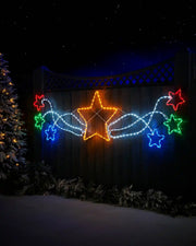 190 cm pre-lit multi-coloured star cluster silhouette displayed outdoors on a fence at night