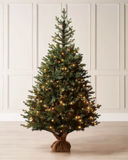 6 ft green artificial Christmas tree with warm lights displayed in a room