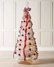 Pre-lit red and white pop-up Christmas tree displayed in a room with warm white LED lights