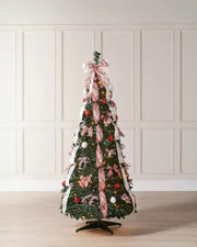 Pre-lit green pop-up decorated Christmas tree with red and white ribbon displayed in a room