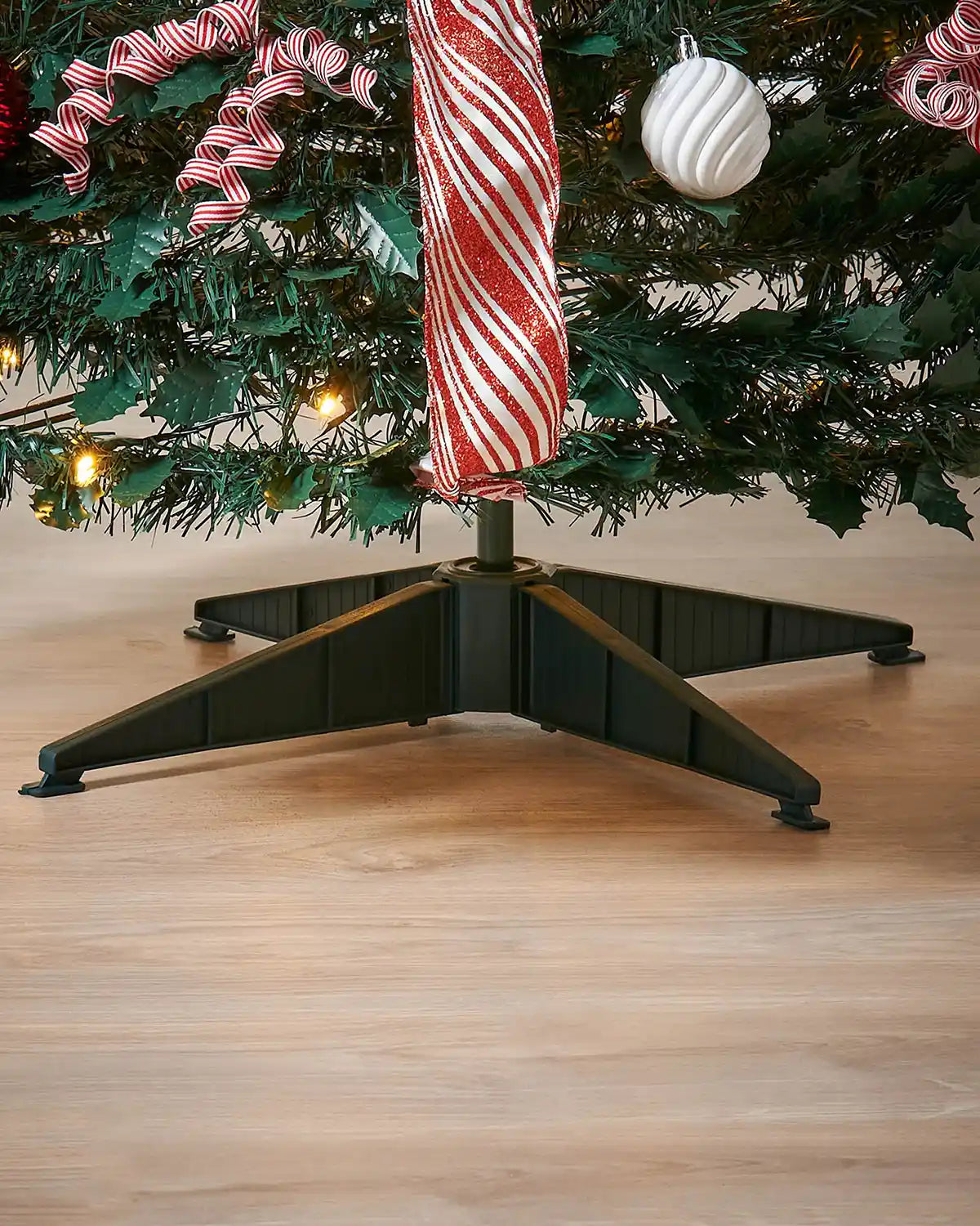 Close-up of the Green stand base for the 6 ft green pre-lit pop-up decorated Christmas tree