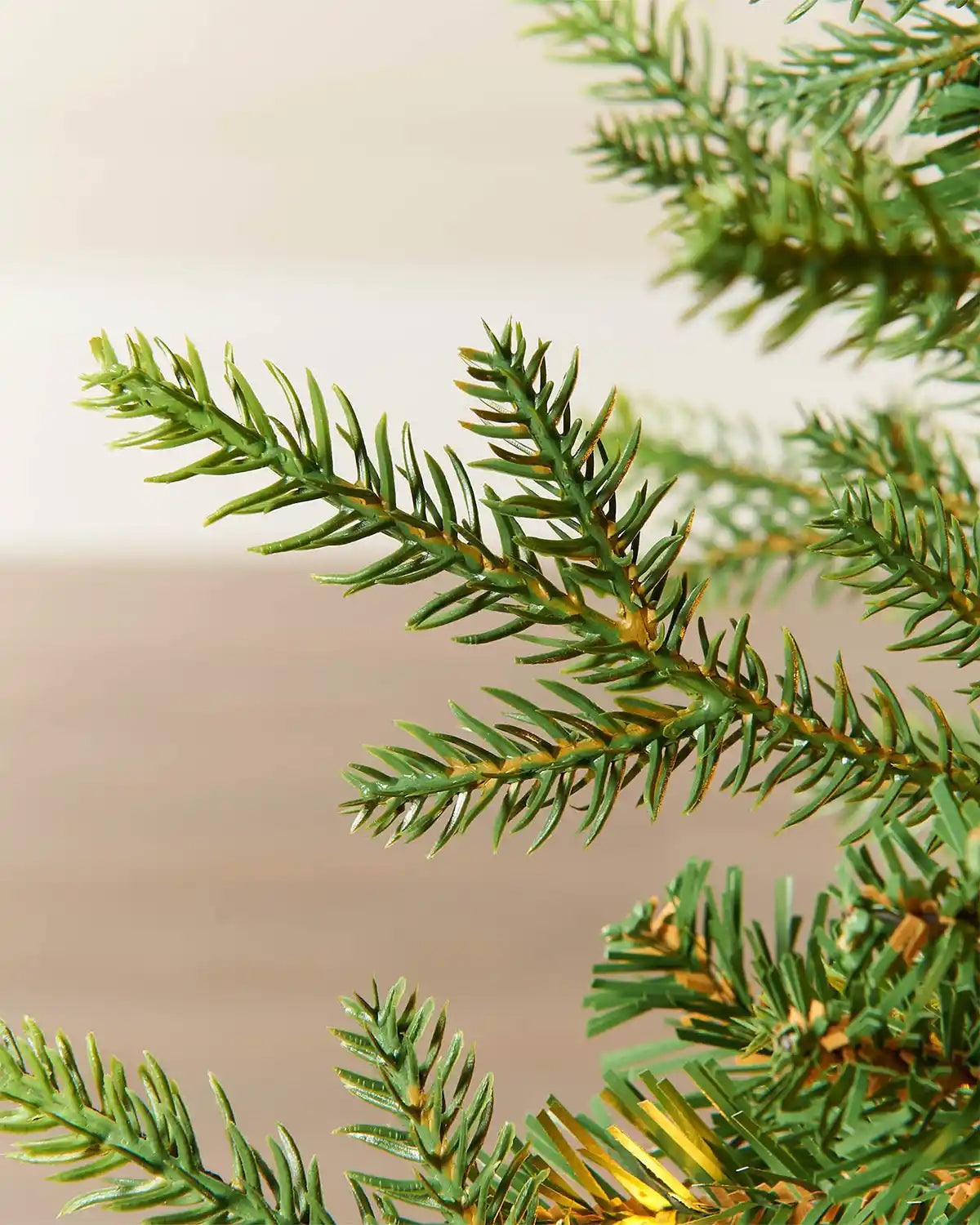Close-up of realistic pine branches on a 4 ft pre-lit potted Christmas tree