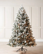 6 ft frosted artificial Christmas tree with warm lights displayed in a room