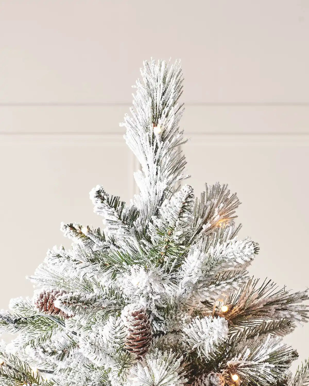 Close-up of the frosted top branches of an artificial Christmas tree