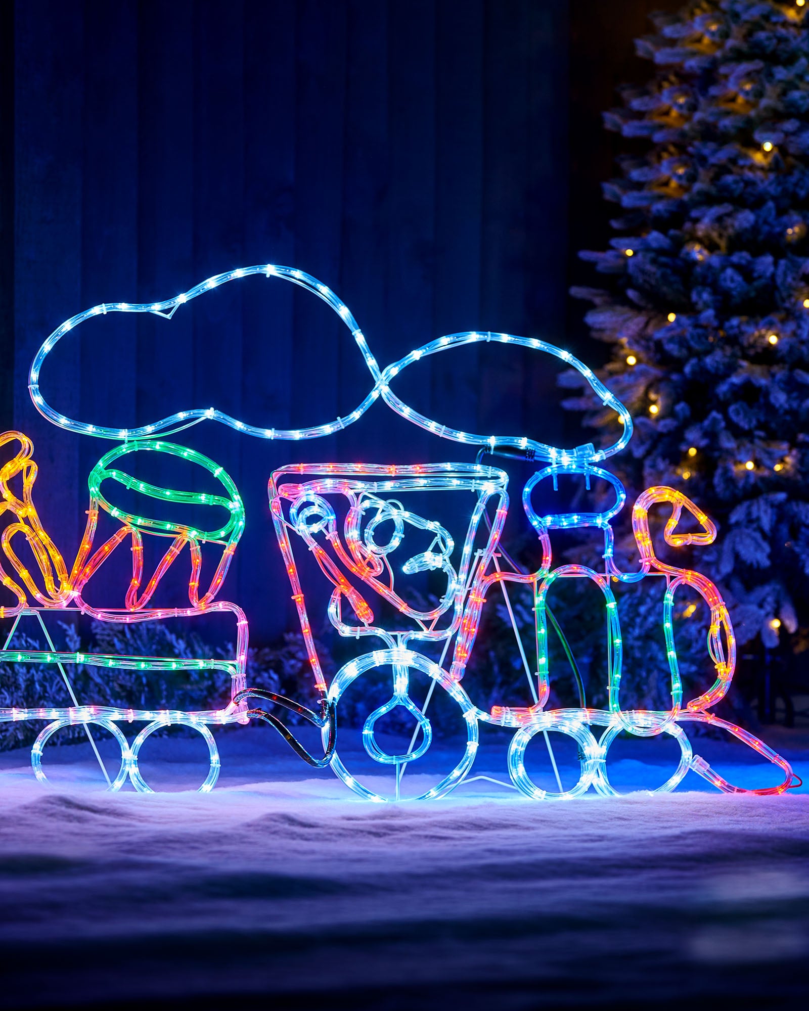 Close-up of the illuminated steam train engine with blue smoke outline and multi-coloured LEDs