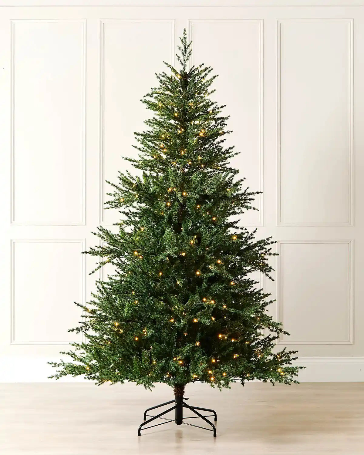 7 ft pre-lit traditional fir Christmas tree with warm white lights displayed in a room