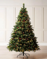 Pre-lit Victorian mixed tip Christmas tree with berries and pinecones displayed indoors with warm white lights