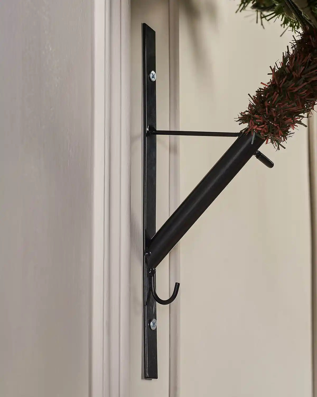 Close-up of the black wall mounting bracket used to secure the pre-lit wall mounted Christmas tree