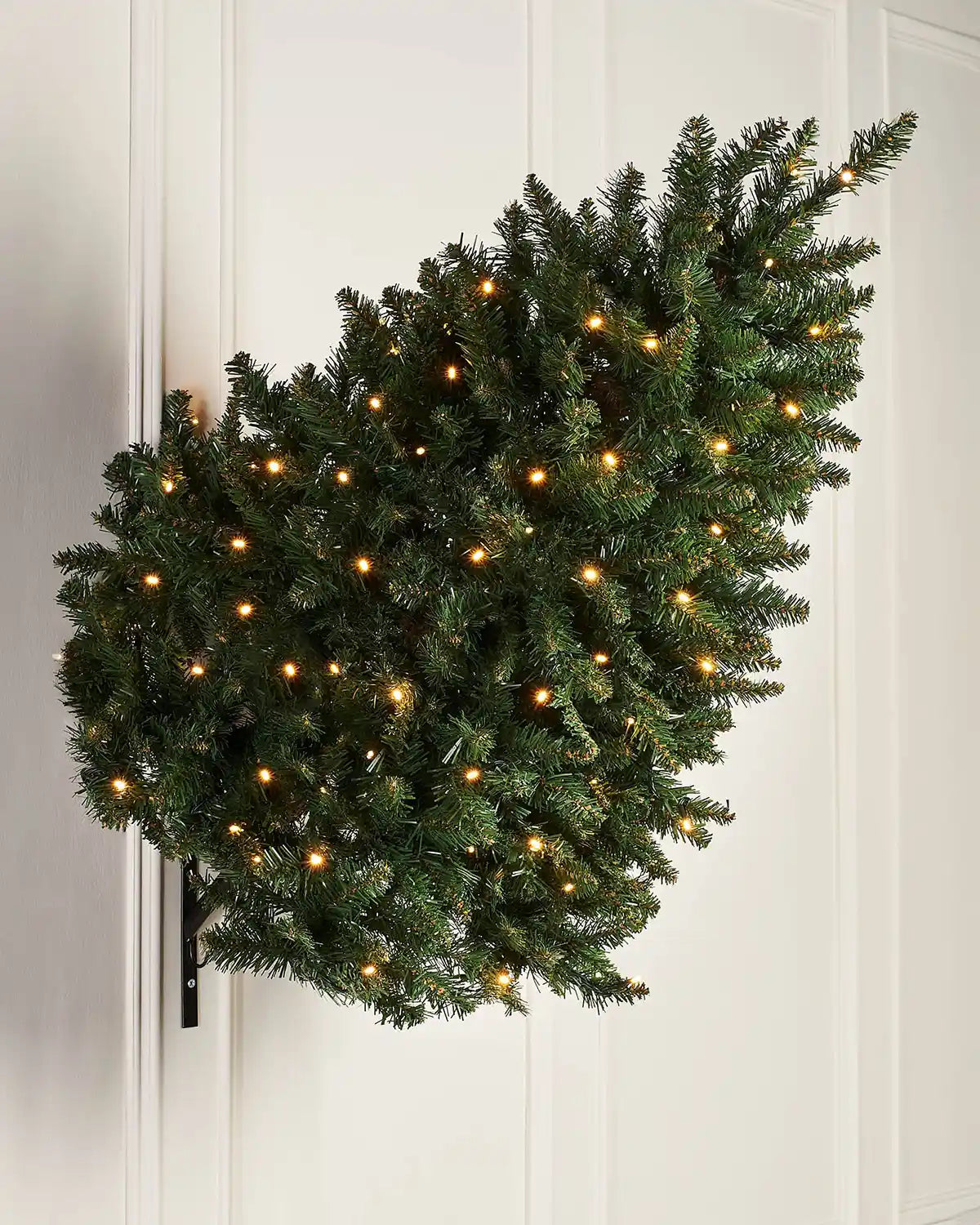 3 ft pre-lit wall mounted Christmas tree displayed on an indoor wall with warm white lights
