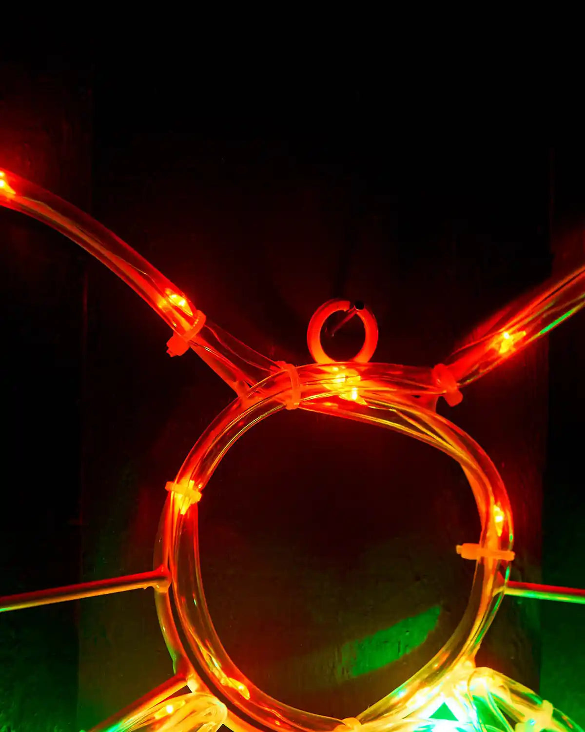 Close-up of the hanging loop and red bow lights on the wreath display