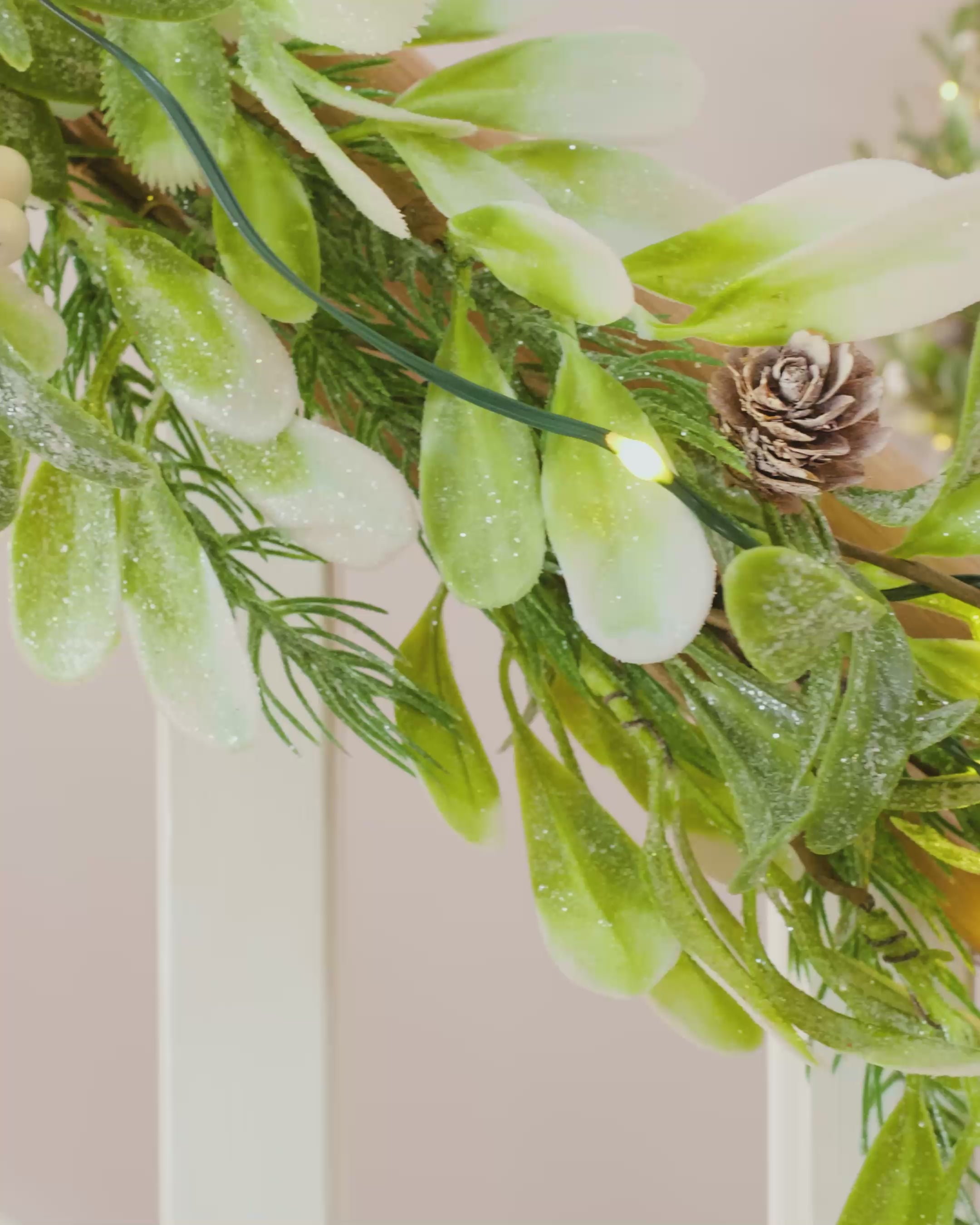 Load video: Pre-Lit Frosted Mistletoe Wreath, 76 cm