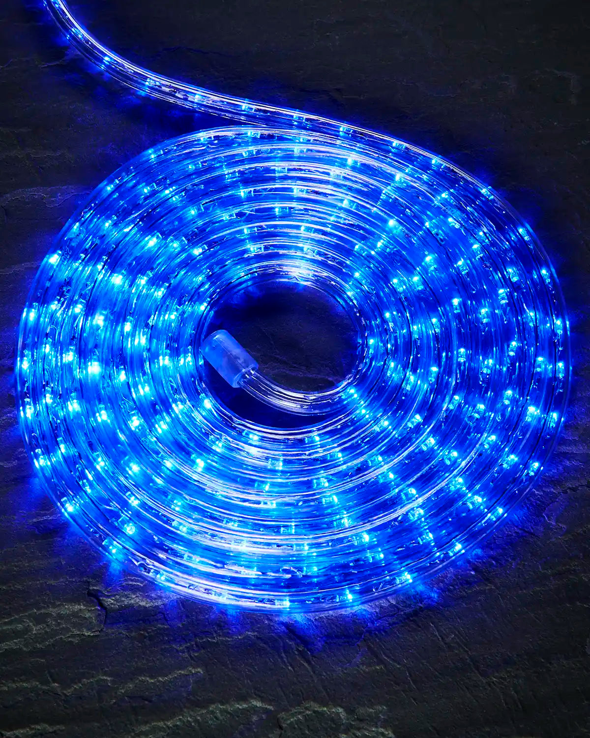 Coiled blue Pro Series rope light on a dark surface with an endcap visible.