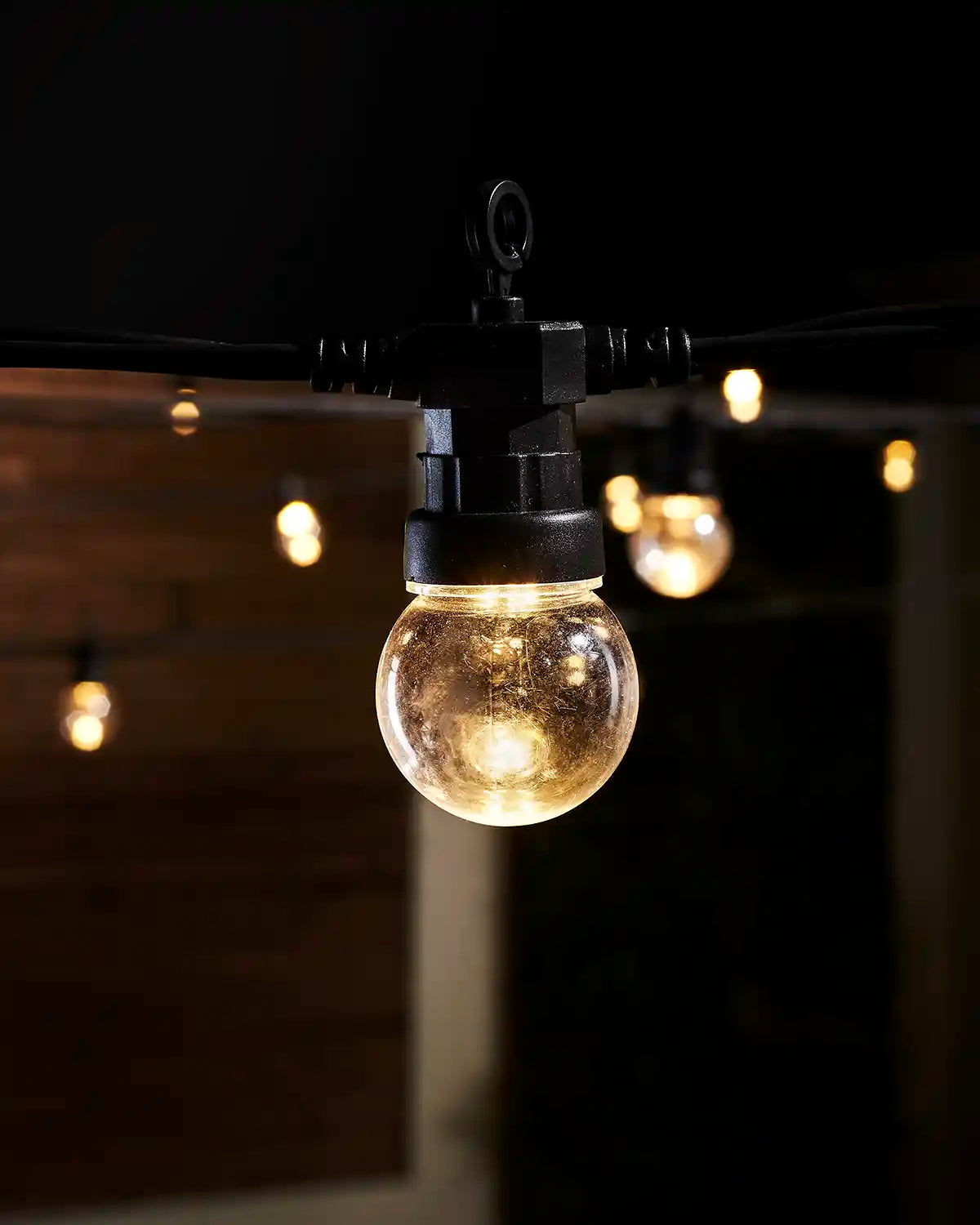 Close-up of a warm white clear bulb festoon light with visible LEDs.