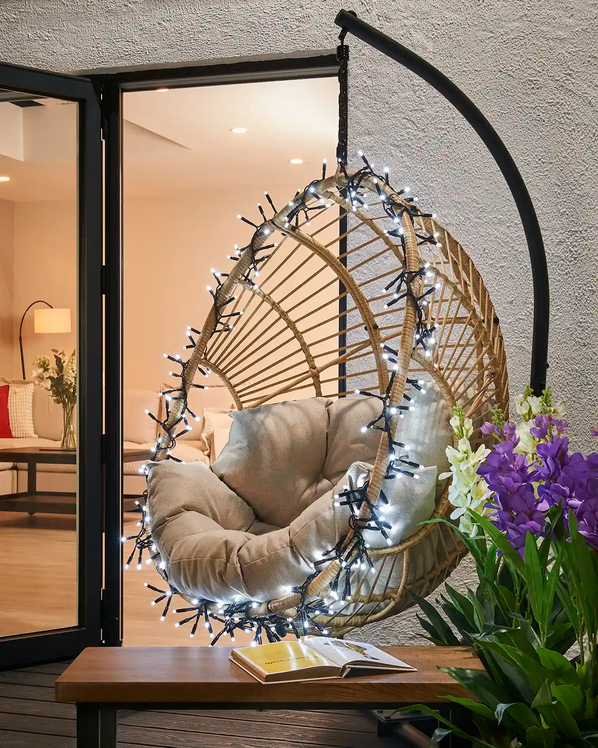 White Pro Series cluster lights wrapped around an outdoor hanging chair.