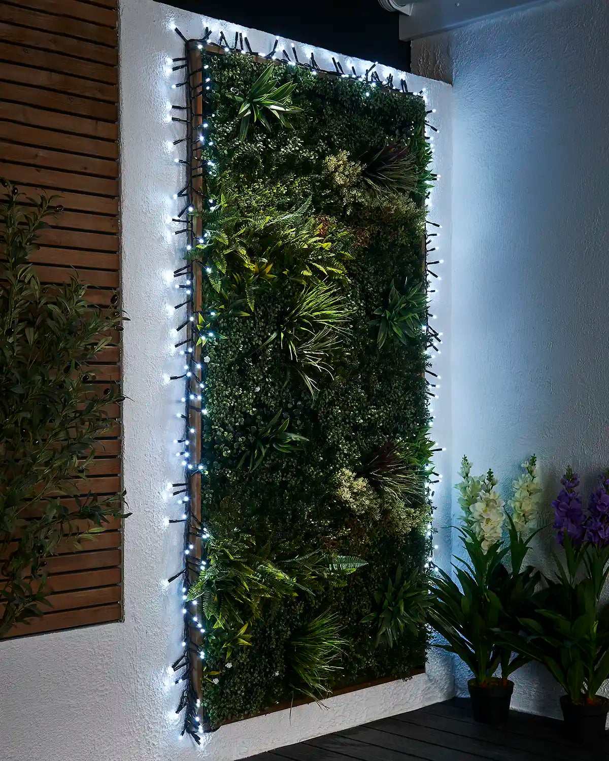 White Pro Series cluster lights framing an outdoor green wall display.