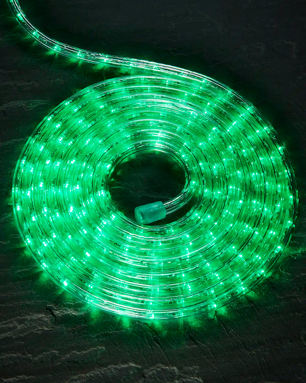 Coiled green Pro Series rope light on a dark surface with an endcap visible.
