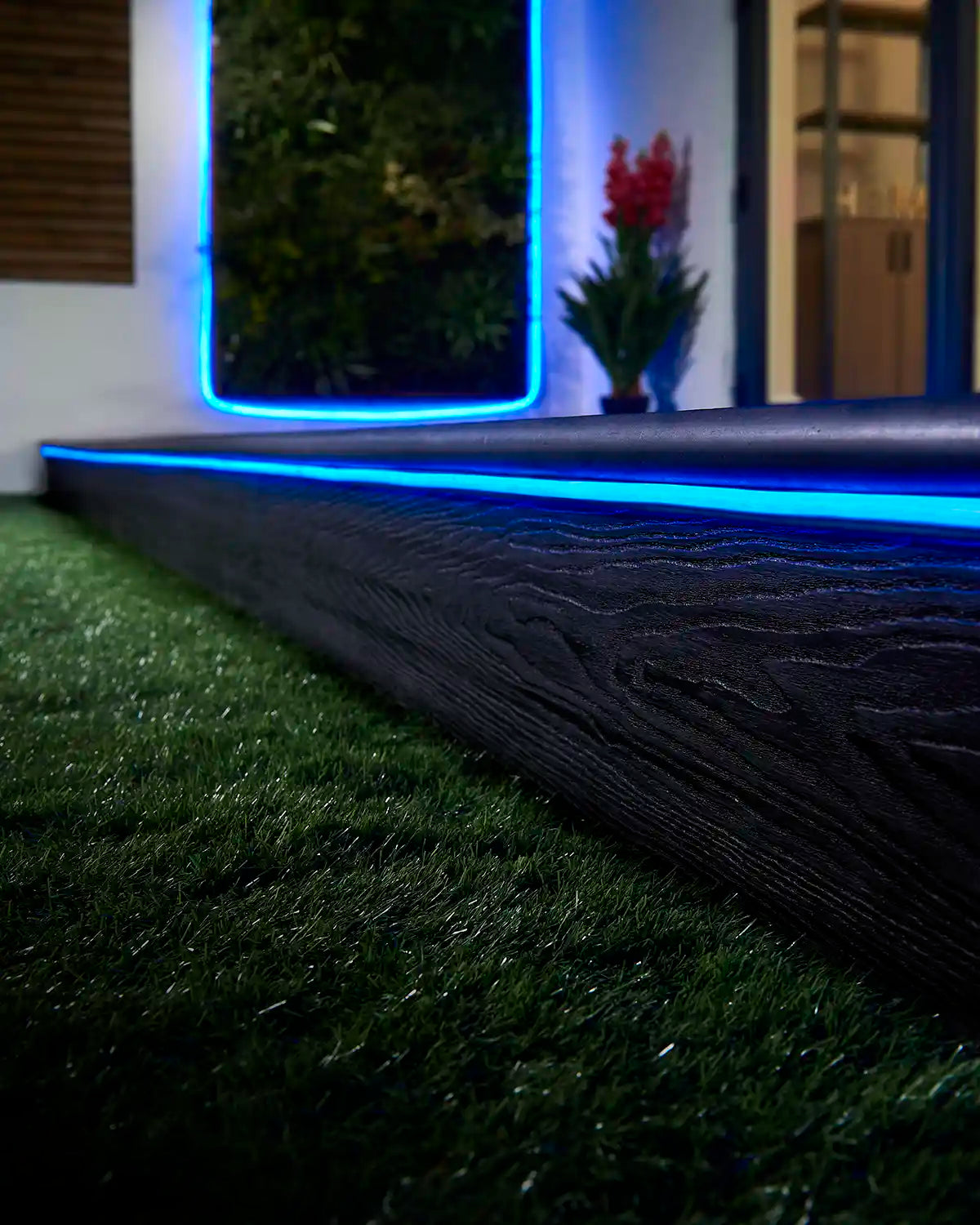 Blue Pro Series Neon Flex installed along outdoor decking and a wall feature.
