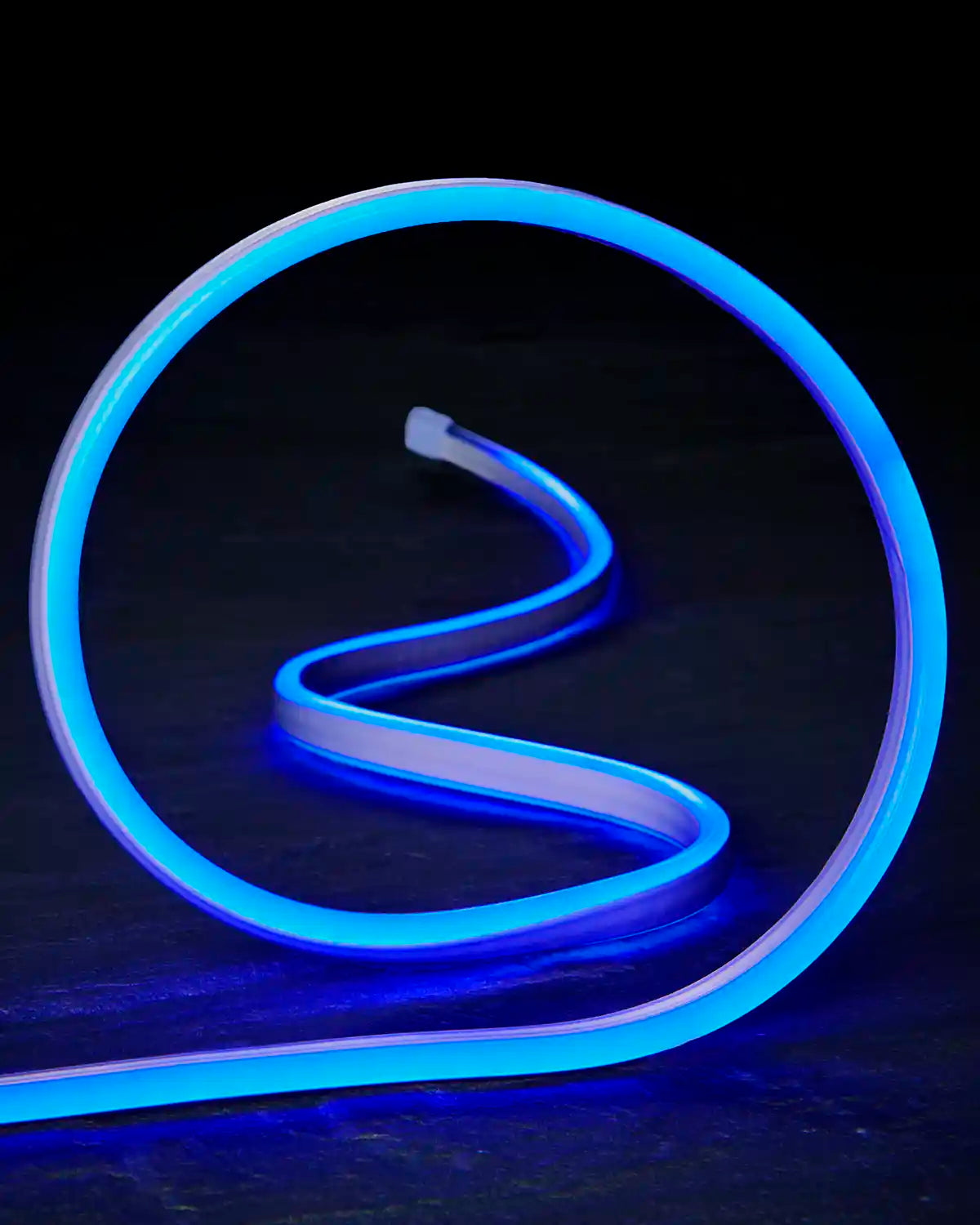 Close-up of flexible blue Neon Flex lighting shaped into a loop.